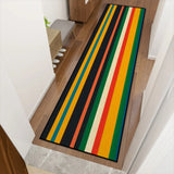 Retro striped hallway runner rug in green and yellow on a wooden hallway floor