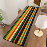 Retro striped hallway runner rug in green and yellow in a hallway with a floor lamp