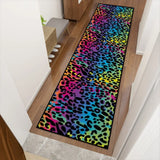 Top-down view of rainbow leopard hallway runner rug on a wood floor entryway