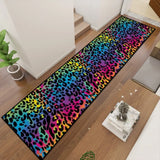Angled view of rainbow leopard runner rug in a hallway next to a small table with decor