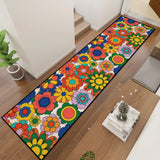Colorful flower pattern hallway runner rug at a diagonal angle in a hallway with a sideboard and decor