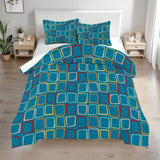 Queen comforter set with teal and blue squares outlined in yellow on a bed with two bedside tables