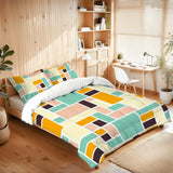 Color block comforter set on a bed in a room with wooden shelves and a desk