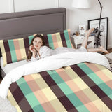 Woman relaxing on a bed with the plaid comforter set and a gray headboard
