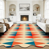 Red and teal triangle-pattern scalloped area rug in a living room with fireplace and white sofas