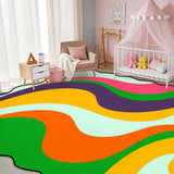 Rainbow swirl scalloped area rug in a nursery with crib and pink canopy