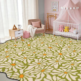 Olive green daisy-pattern scalloped area rug in a nursery with crib and pink canopy