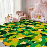 Nursery with a crib and a 9x12 ft green and yellow geometric scalloped area rug on the floor