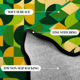 Close-up of the green and yellow geometric pattern with a lifted scalloped edge showing stitching and backing