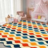 Wavy-stripe navy and orange scalloped area rug in a nursery with crib and pink canopy