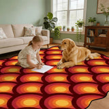 Child and golden retriever on red and orange arch-pattern scalloped area rug