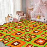 Orange and green square-pattern scalloped area rug in a nursery with crib and pink canopy
