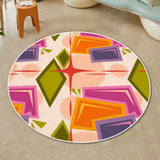 Top view of round rug with white border and pink, purple, orange and olive shapes on peach