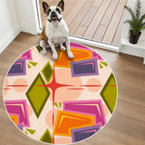 Small dog sitting on a round rug with pink, orange and olive geometric pattern