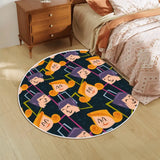 Navy cartoon-face round rug with white border beside a bed and wooden nightstand