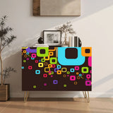 Retro wooden cabinet with colorful retro square doors and hairpin legs with a tall plant and framed art in a bright room