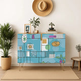 Retro wooden cabinet with hand-drawn daisies and palm leaves on sky blue and metal hairpin legs